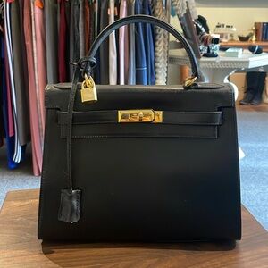 Luxury handbag. Black leather with gold hardware